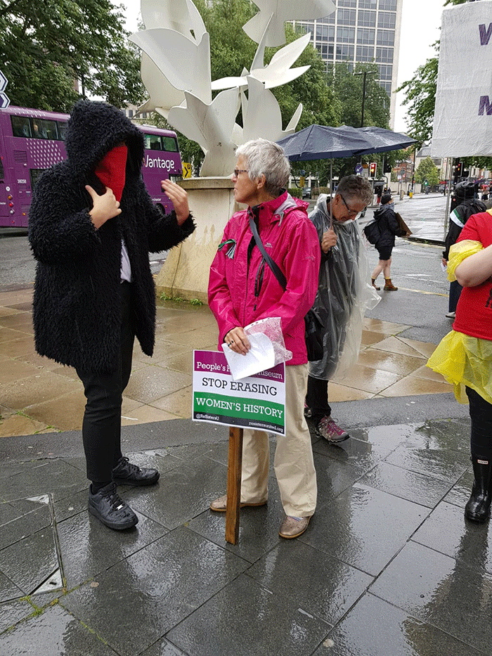 Women's rights protester interacting with trans activist counter-protester